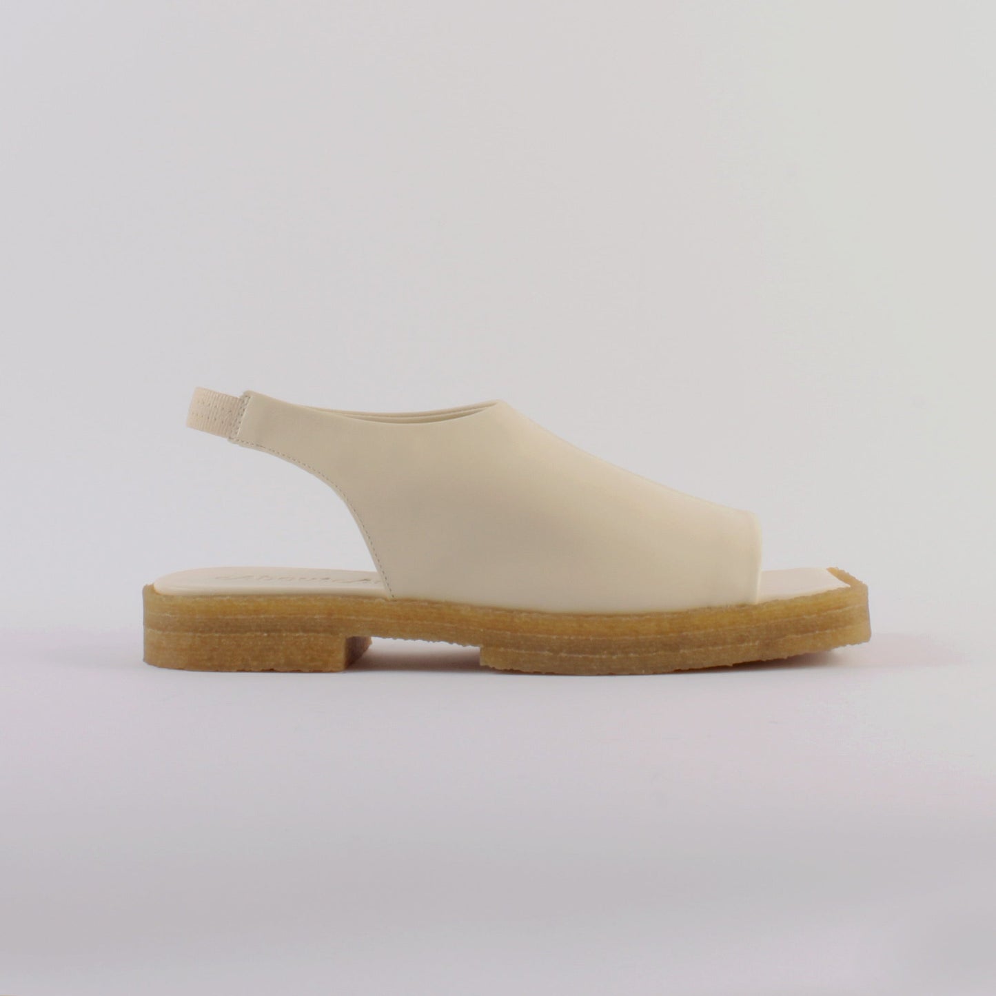 Unlined block platform sling-back sandals made of cream coloured lamb leather with a subtle shiny finish