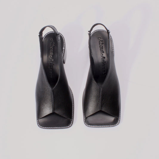 About Arianne block heel sling-back sandals made of black tumbled leather with raw edges
