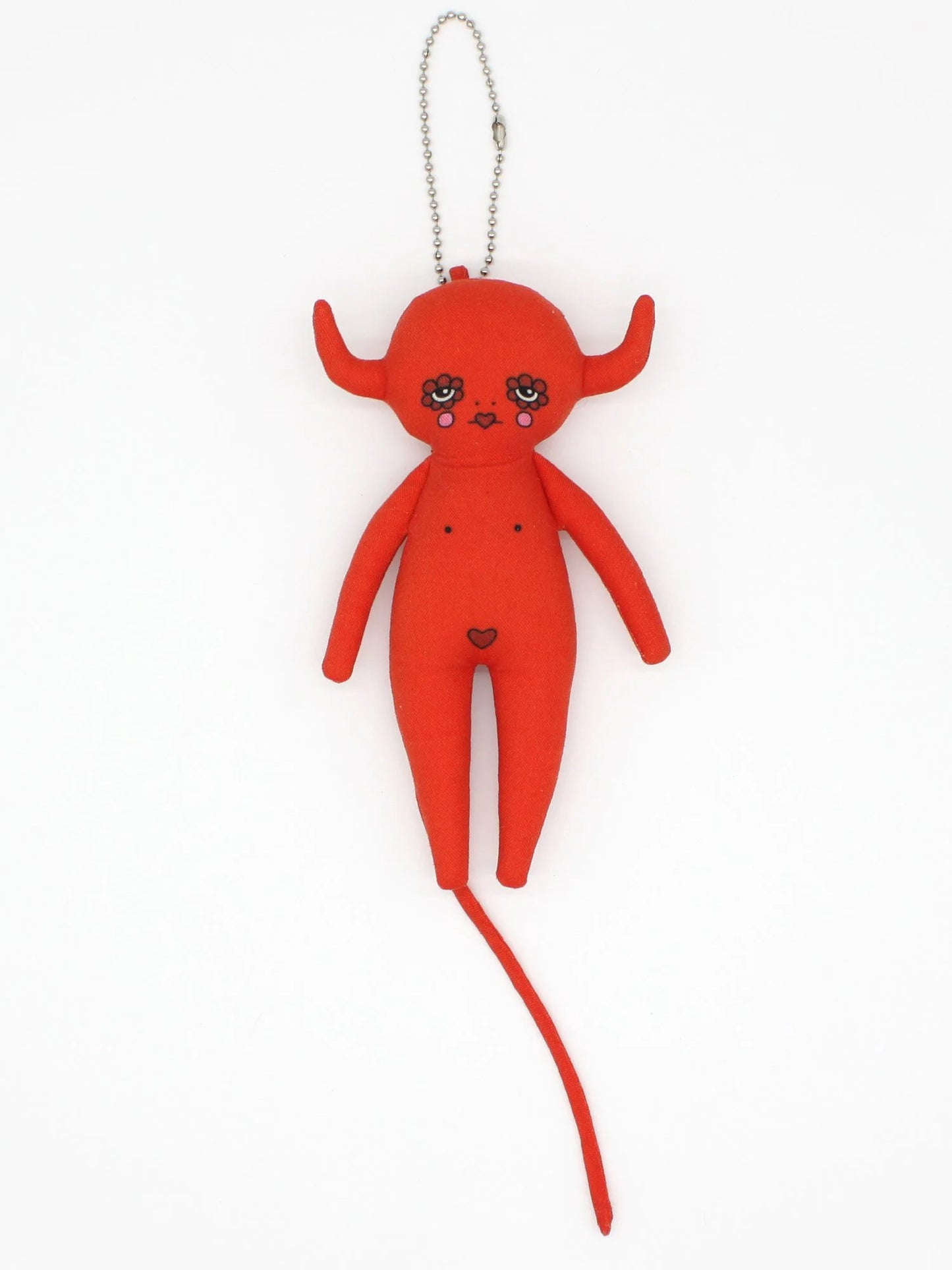 Red plush toy with horns and a long tail on a white background