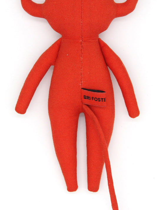 Red stuffed toy with 'Bri Foster' branding on a white background