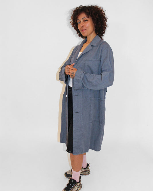 Person wearing a blue coat on a white background