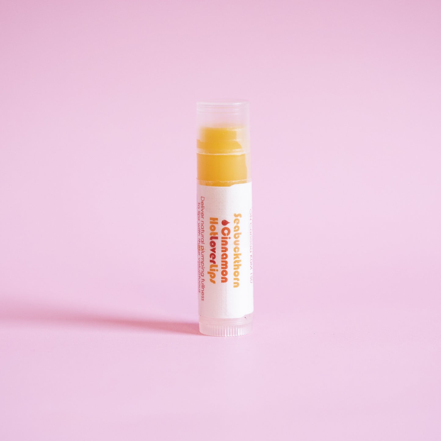 Living Libations Seabuckthorn Cinnamon Hot Lover Lips balm. Available at Easy Tiger Toronto.