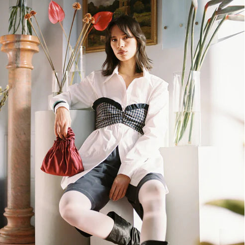 Woman sitting in a stylish room with plants and decor