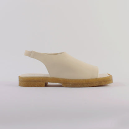 Unlined block platform sling-back sandals made of cream coloured lamb leather with a subtle shiny finish