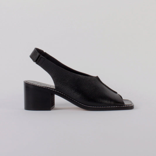 About Arianne block heel sling-back sandals made of black tumbled leather with raw edges