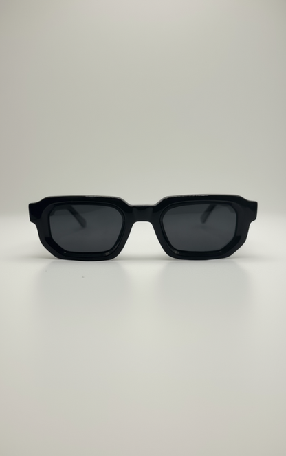 Black sunglasses with dark lenses on a white background