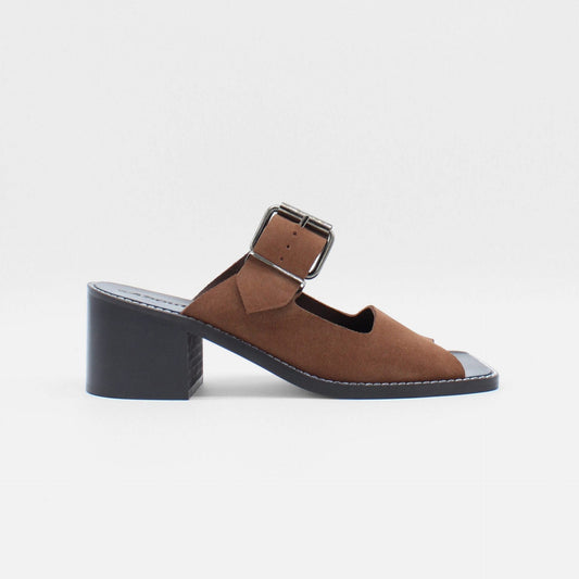About Arianne mocha brown block heel mules made of brown split-cow leather with raw edges and a resined interior