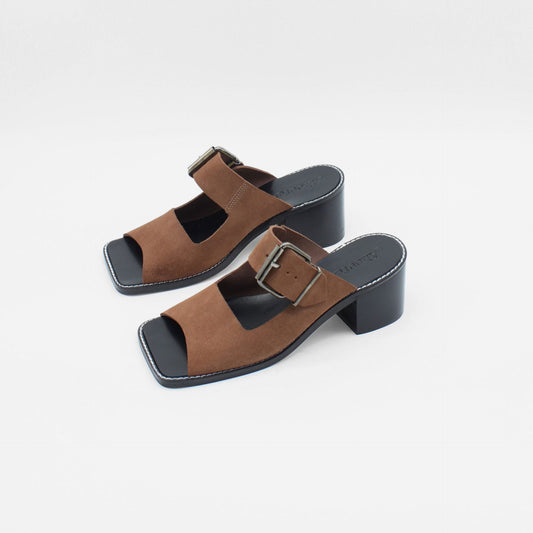 About Arianne mocha brown block heel mules made of brown split-cow leather with raw edges and a resined interior