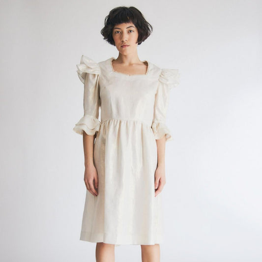 Batsheva Antoinette Dress in Gold Coated Linen. Available at EASE Toronto. 