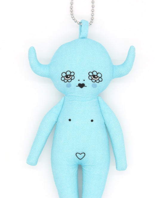 Blue plush toy devil charm with floral design eyes on a white background