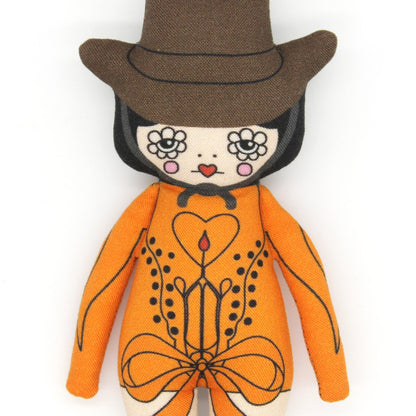 Plush toy with orange outfit, brown hat, and black boots on a white background
