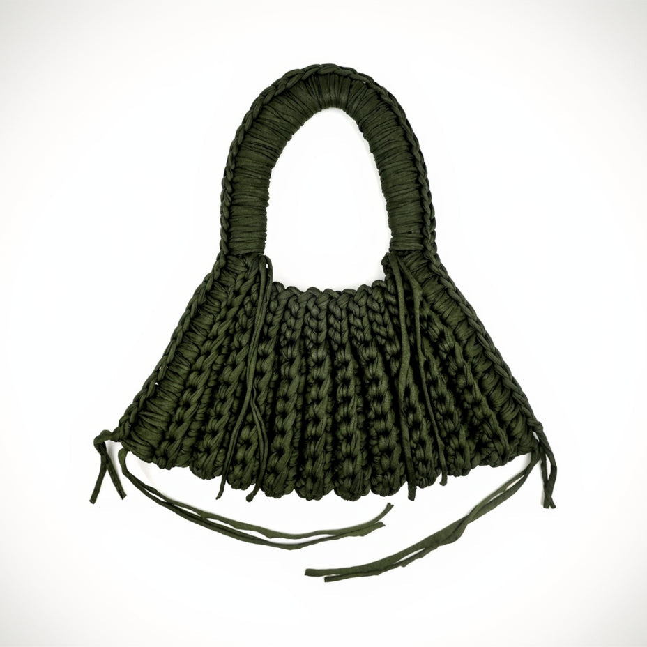 Green woven handbag on a white background