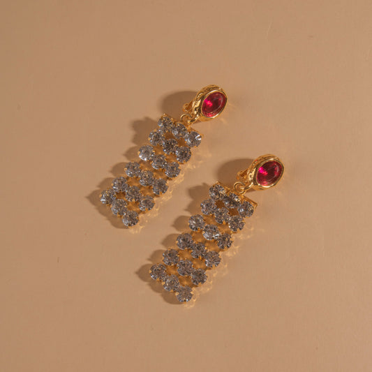 Pair of 18k gold plated clip-on earrings with glass crystal center stone and crystal chain.