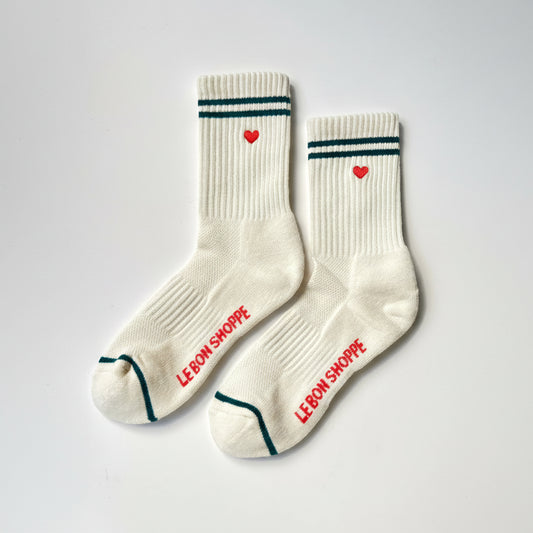 White socks with red hearts and 'LE BON SHOPPE' text on a light gray background