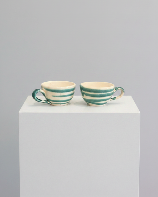 Espresso cups on white pedestal