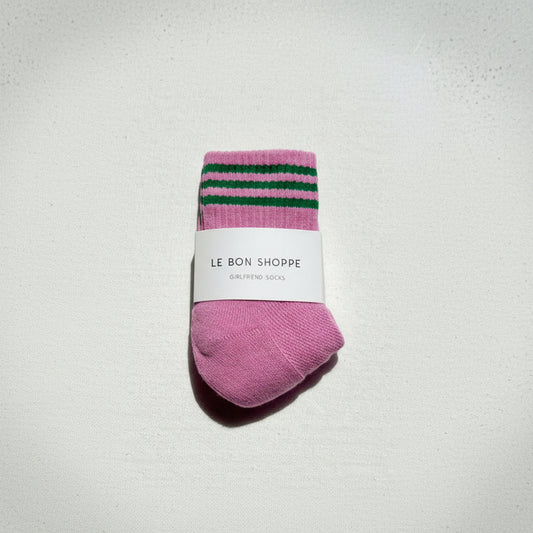 Pink socks with green stripes on a white background, featuring 'Le Bon Shoppe' label.