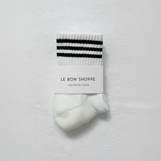 White sock with black stripes on a white background, featuring 'Le Bon Shoppe' packaging.