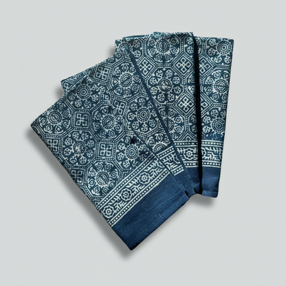 Blue patterned fabric napkins on a white background