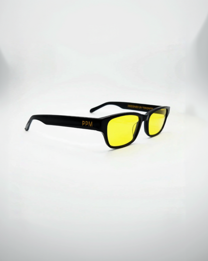 Black-framed sunglasses with yellow lenses on a white background