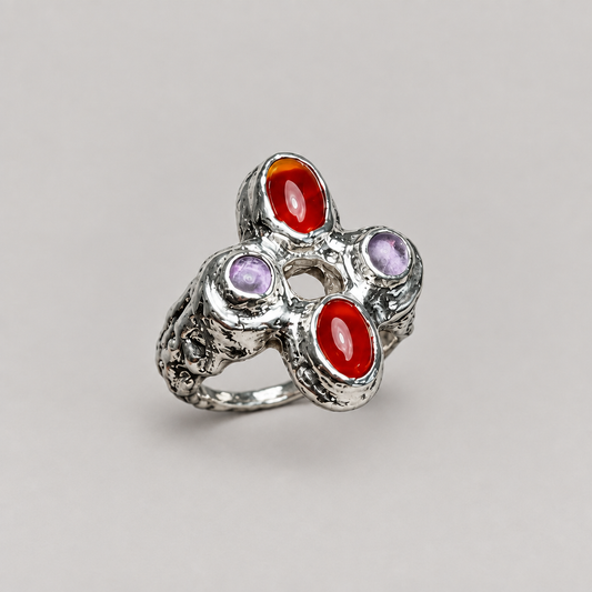Ring with a subtly slimmer band on a neutral seamless background