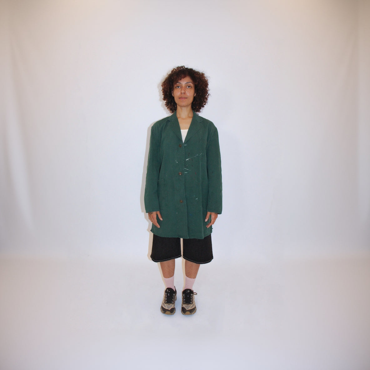 Person wearing a green coat on a white background