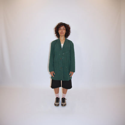 Person wearing a green coat on a white background