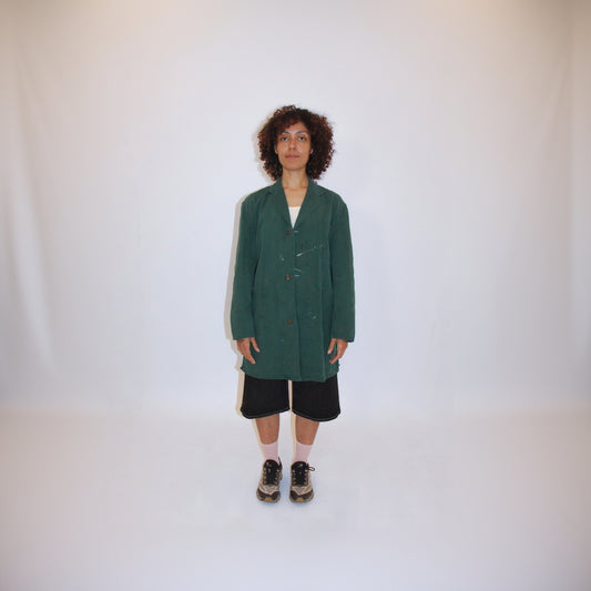 Person wearing a green coat on a white background
