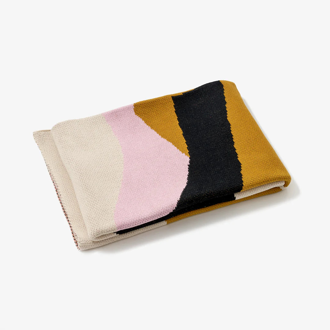 Reversible knit Assembly throw blanket with graphic shapes