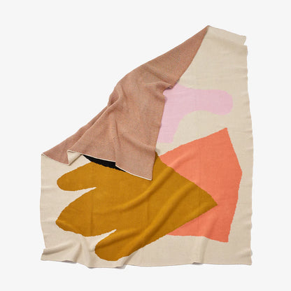 Reversible knit Assembly throw blanket with graphic shapes