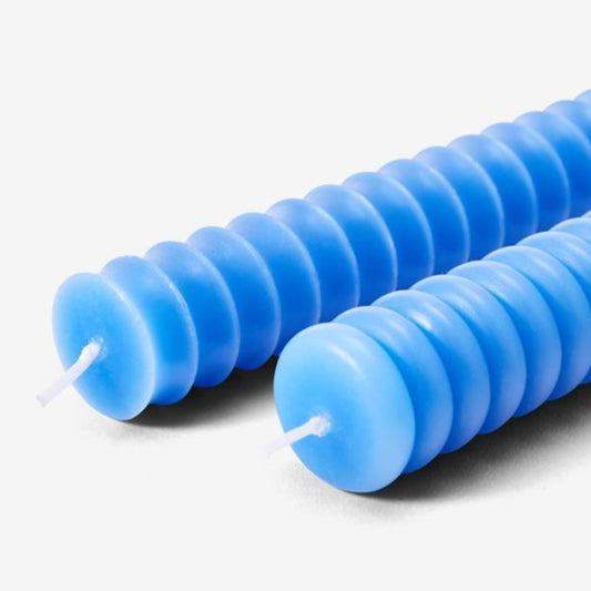 Two cobalt blue taper candles with ribbed texture
