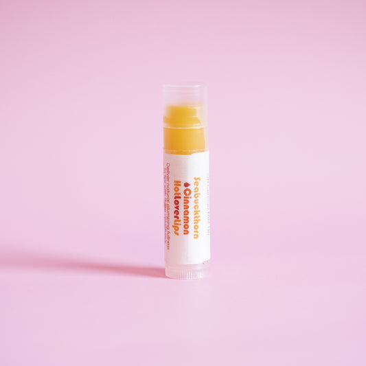 Living Libations Seabuckthorn Cinnamon Hot Lover Lips balm. Available at Easy Tiger Toronto.
